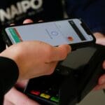 black android smartphone with a digital wallet holding showing emoney